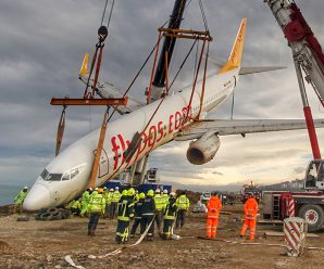 Stricken plane that came off the runway is lifted from slope